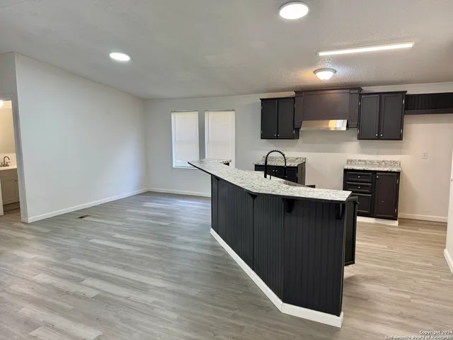 a kitchen with a sink and cabinets