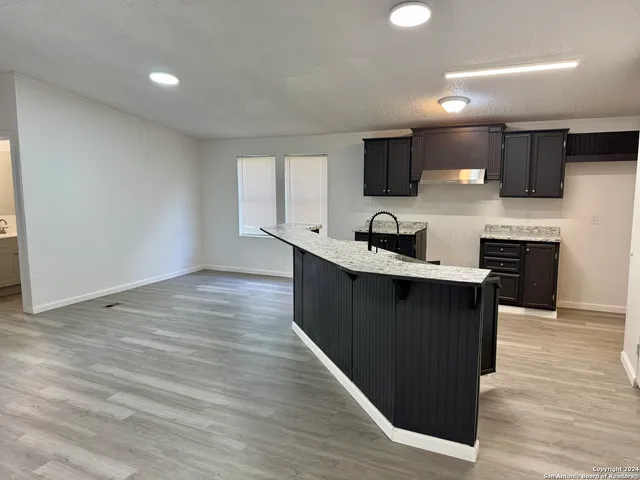 a kitchen with a sink and cabinets