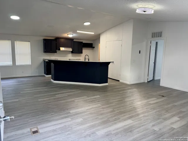 a kitchen with stainless steel appliances kitchen island wooden cabinets and granite counter tops