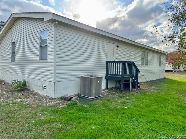 a white house that has a table and chairs in it