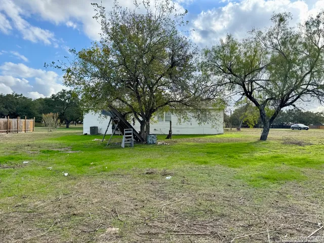 a view of a park with large trees