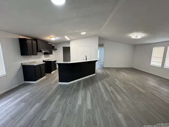 a view of kitchen and wooden floor