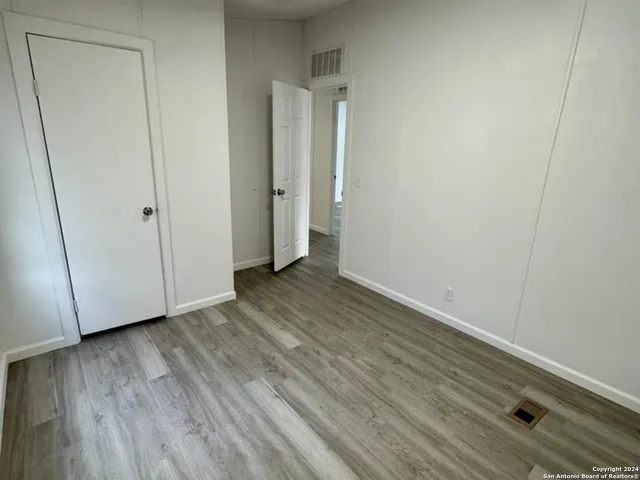 a view of an empty room and wooden floor