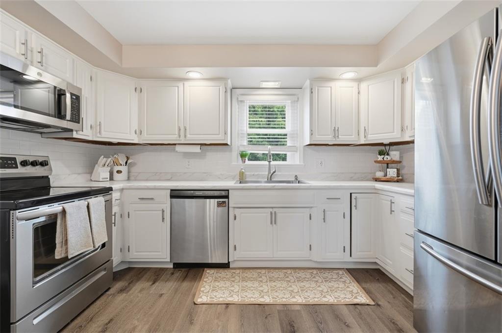 129 Meadowbrook Road Renfrew, PA 16053 - Photo 7 of 45 a kitchen with stainless steel appliances granite countertop a stove a sink and white cabinets