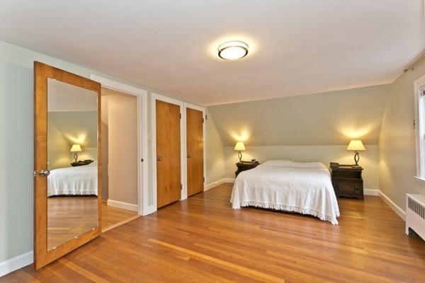20 Spring Street Wakefield, MA 01880 - Photo 16 of 30 a spacious bedroom with a bed and a lamp