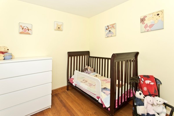 20 Spring Street Wakefield, MA 01880 - Photo 21 of 30 a bedroom with a bed and wooden floor