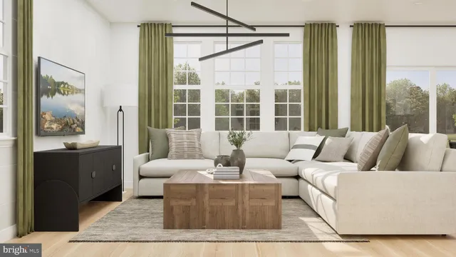 a living room with furniture and large windows