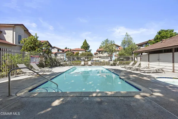 a view of a swimming pool with furniture