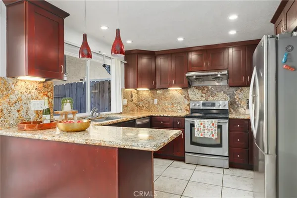 a kitchen with stainless steel appliances granite countertop a sink and cabinets