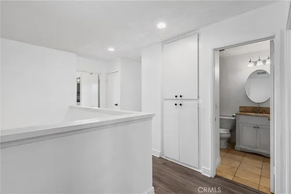 a view of a kitchen from the hallway with a sink