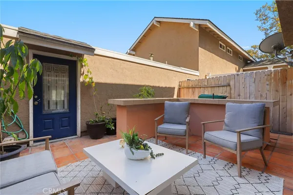 a backyard of a house with table and chairs