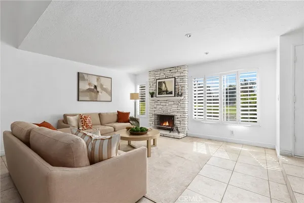 a living room with furniture and a fireplace