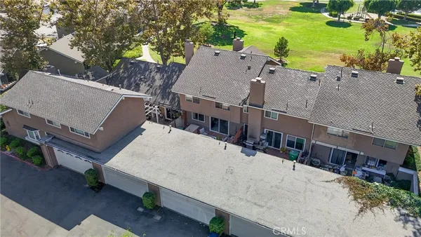 an aerial view of a house with a yard