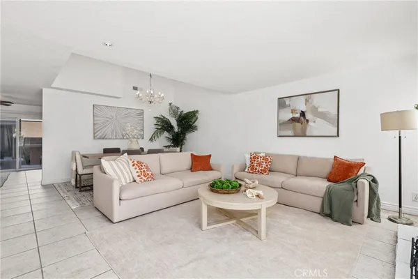 a living room with furniture and a painting on the wall