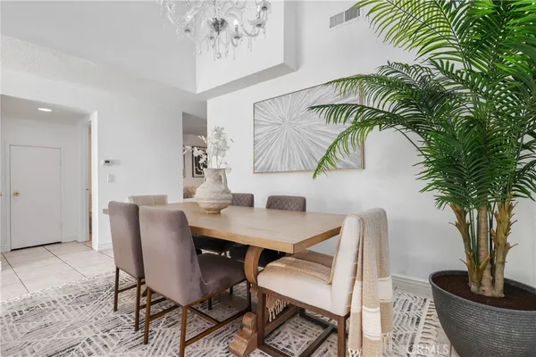 a view of a dining room with furniture and a potted plant