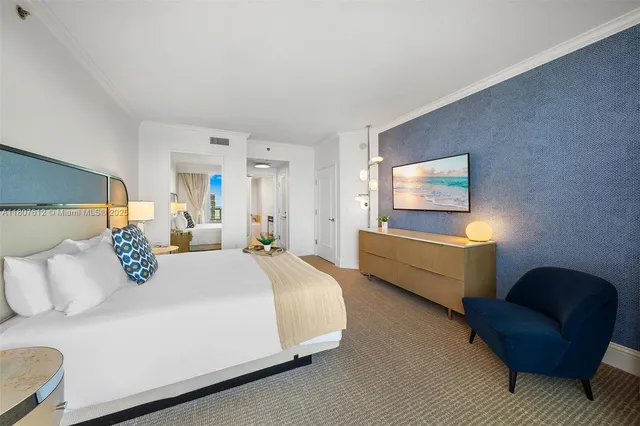 a bedroom with furniture and a lamp