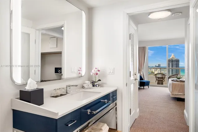 a bathroom with a sink mirror and vanity