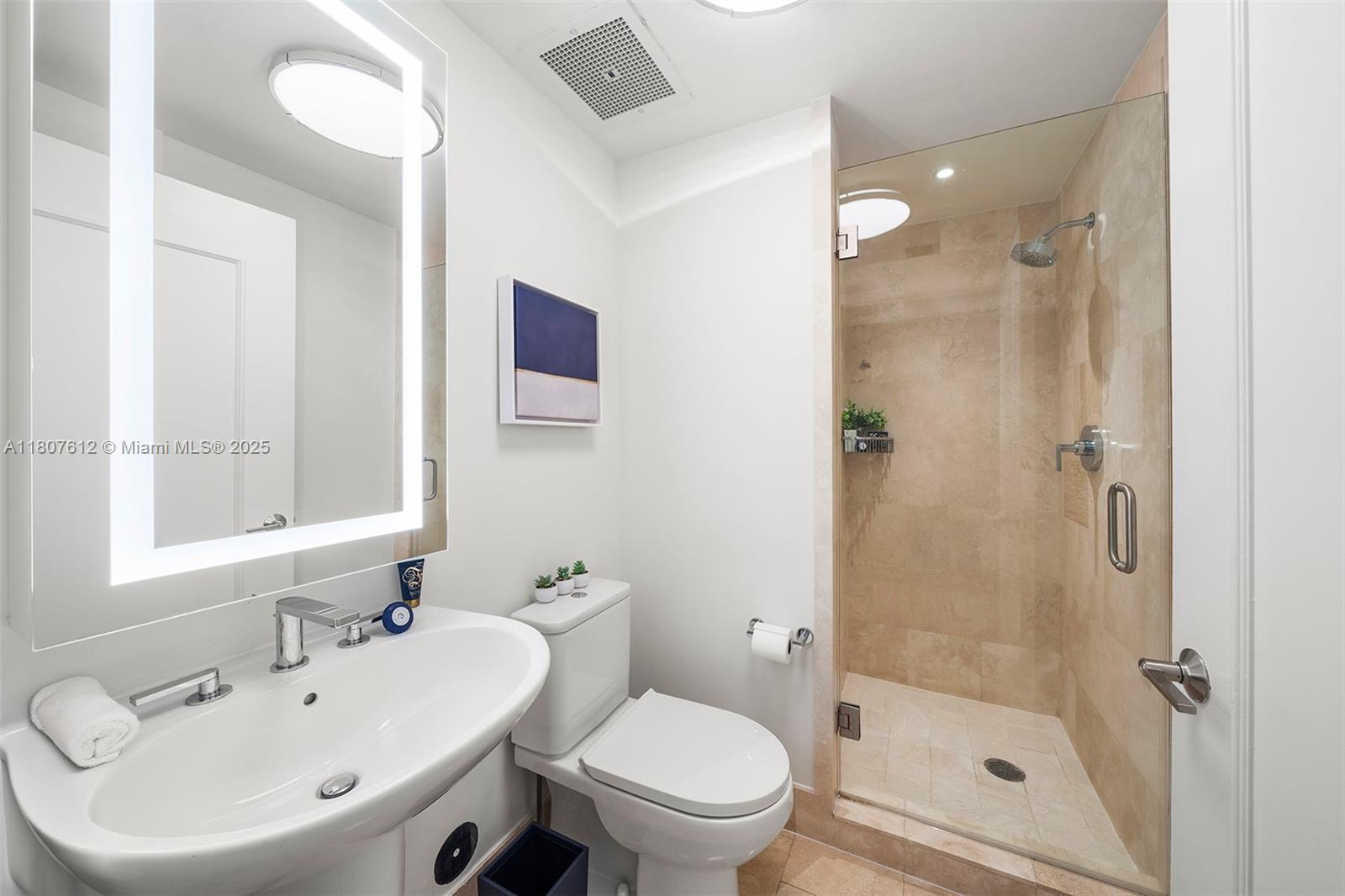 4401 Collins Avenue, Unit 3505 Miami Beach, FL 33140 - Photo 22 of 27 a bathroom with a bathtub shower sink mirror and toilet