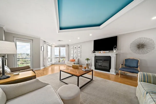 a living room with furniture a flat screen tv and a fireplace