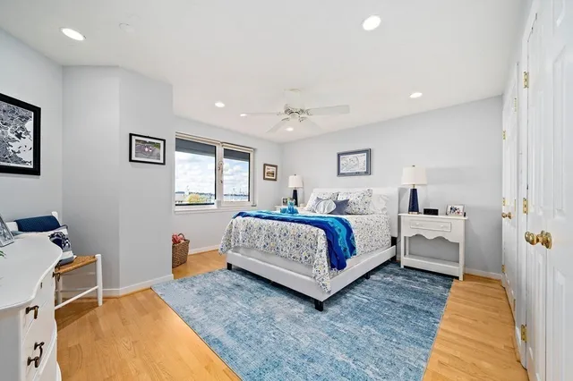 a bedroom with a large bed and a chandelier