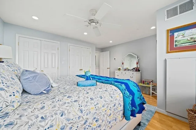 a bedroom with a bed and ceiling fan