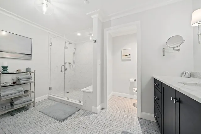 a bathroom with a shower sink and mirror