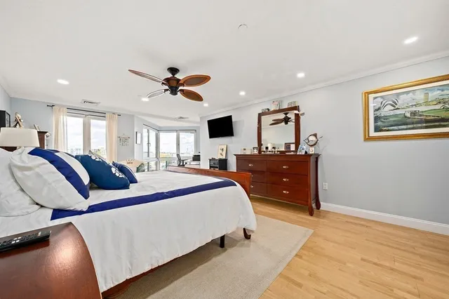 a bed room with a bed and a ceiling fan