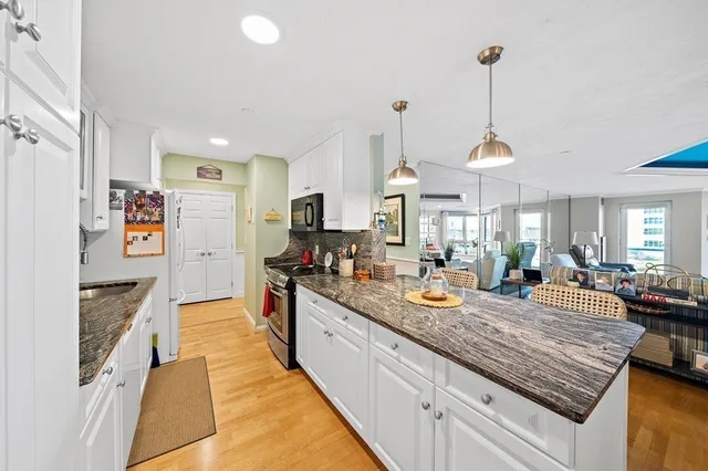 a kitchen with stainless steel appliances granite countertop stove top oven and refrigerator