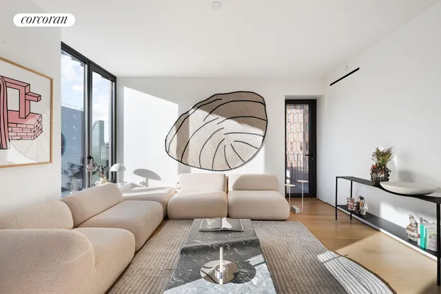 a living room with furniture a couch and wooden floor