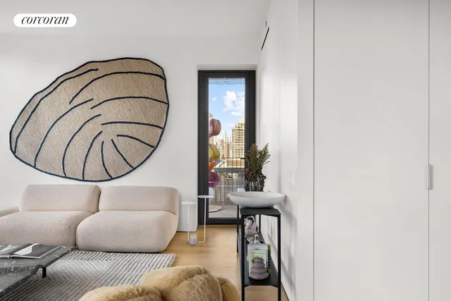 a living room with furniture windows and a potted plant