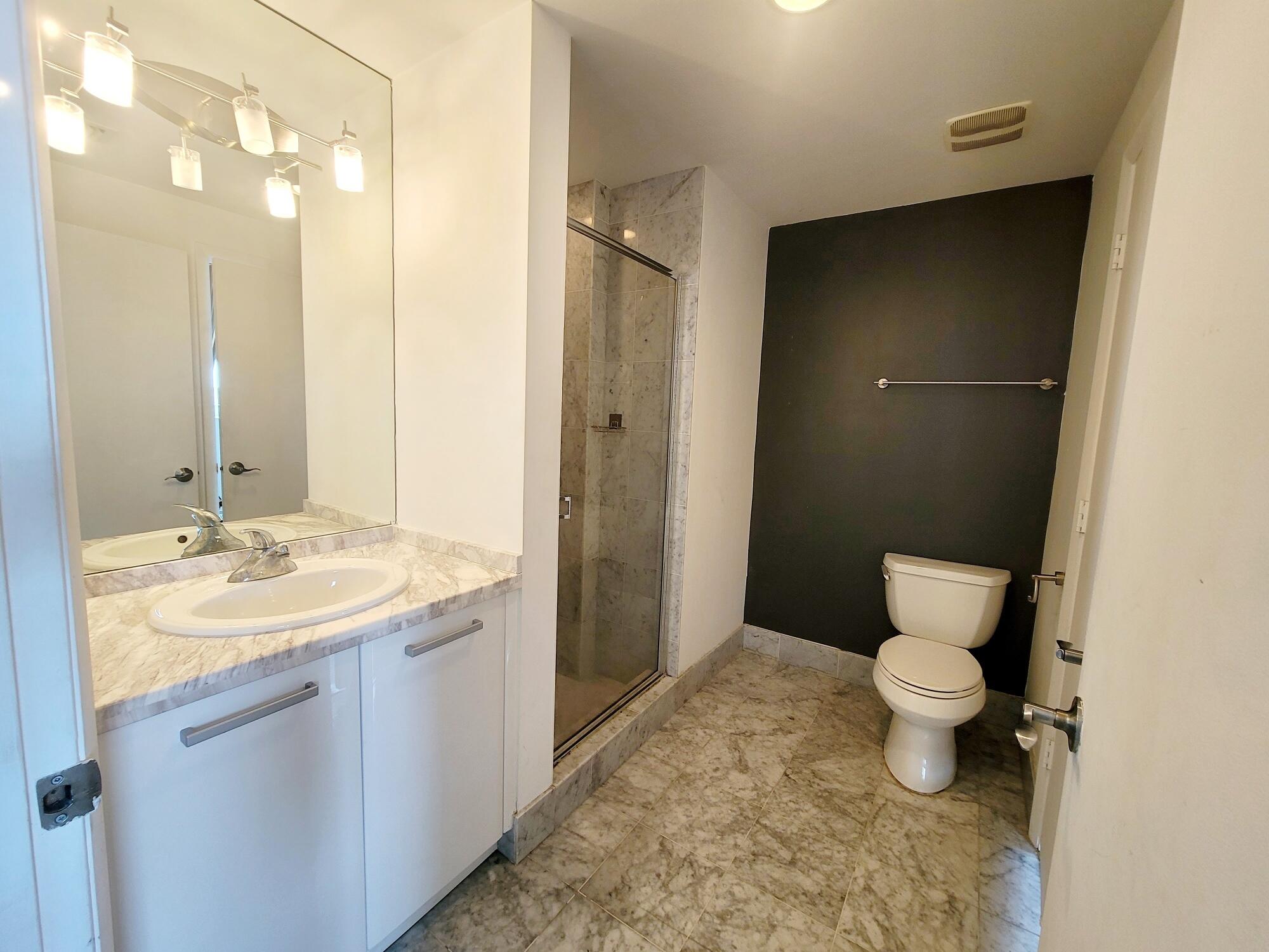 244 Biscayne Boulevard, Unit 401 Miami, FL 33132 - Photo 19 of 36 a bathroom with a sink and a mirror