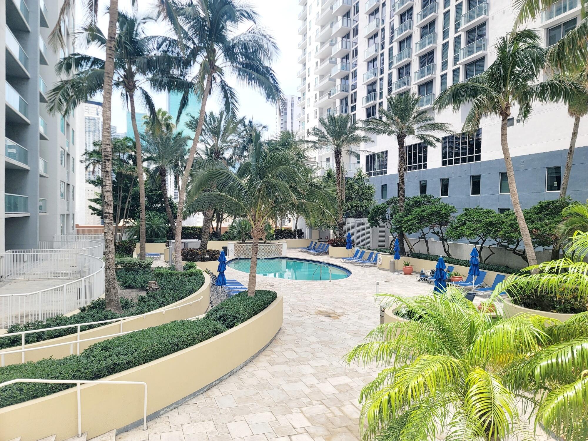 244 Biscayne Boulevard, Unit 401 Miami, FL 33132 - Photo 2 of 36 a view of a swimming pool with a patio