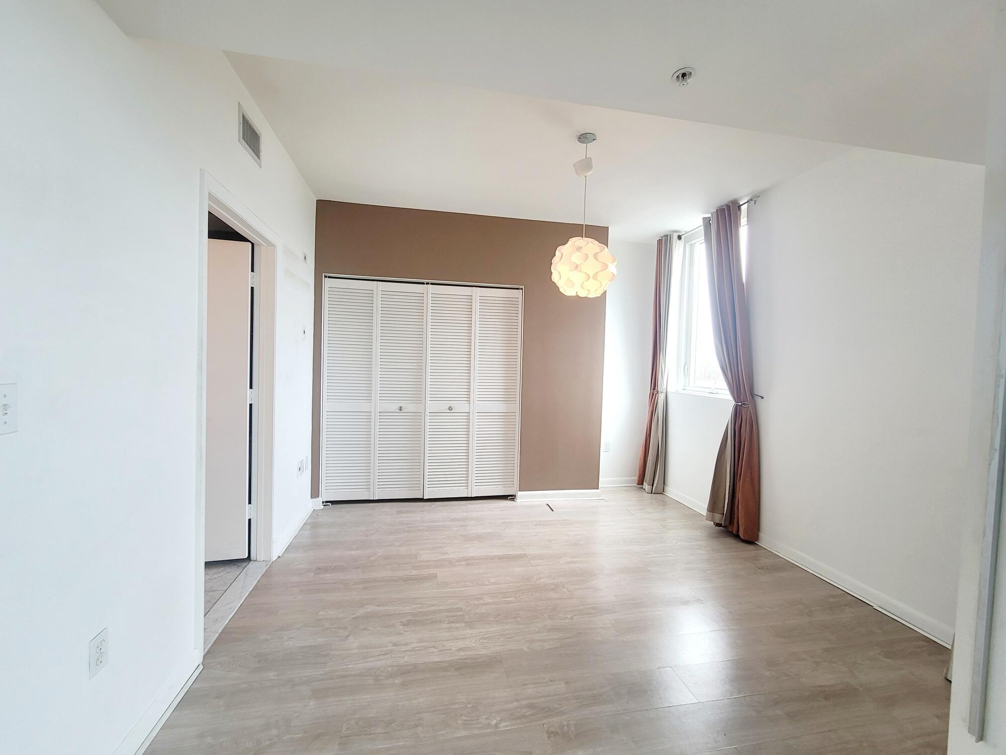244 Biscayne Boulevard, Unit 401 Miami, FL 33132 - Photo 21 of 36 a view of a room with wooden floor and entryway