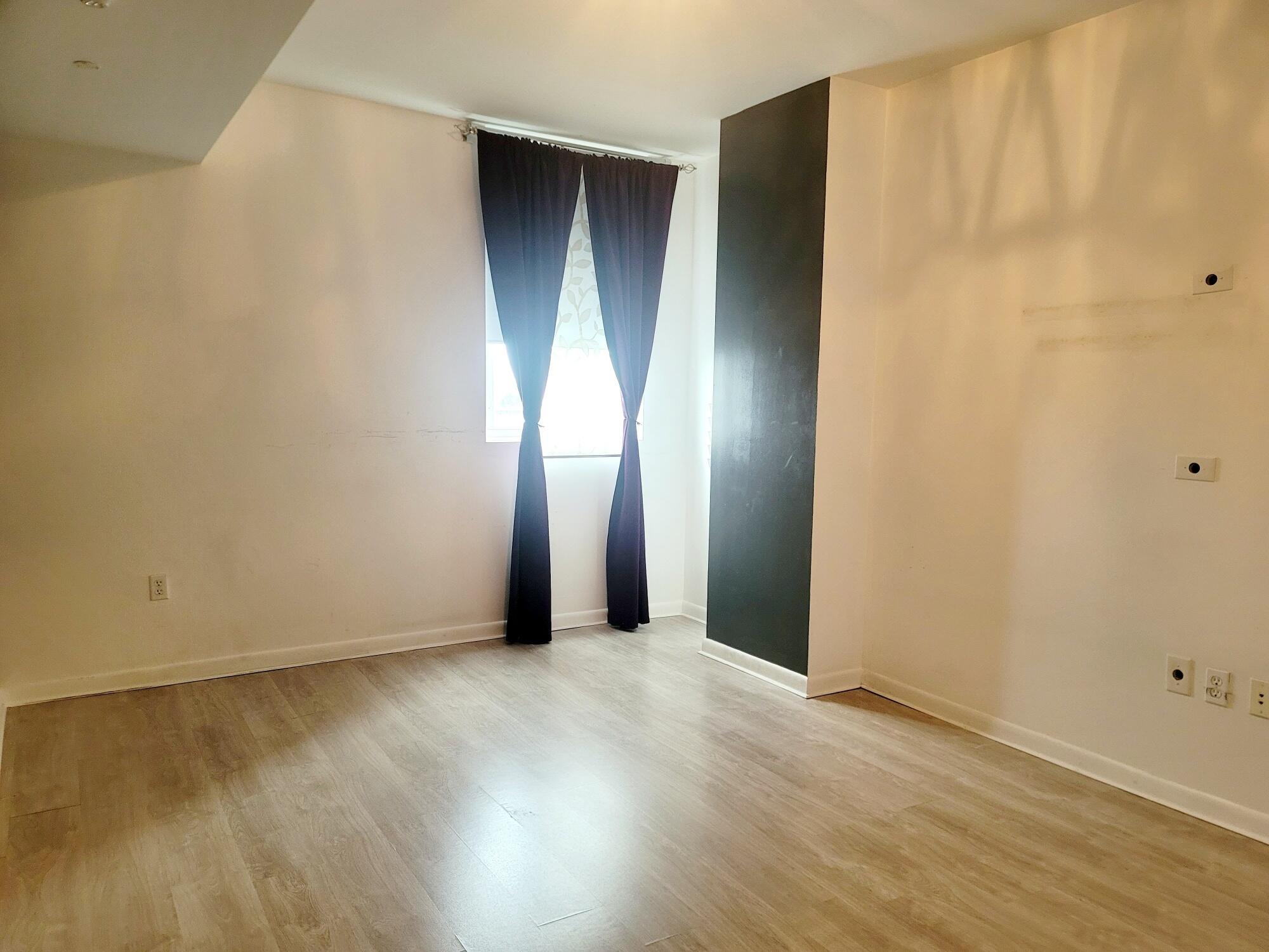 244 Biscayne Boulevard, Unit 401 Miami, FL 33132 - Photo 24 of 36 an empty room with wooden floor and closet