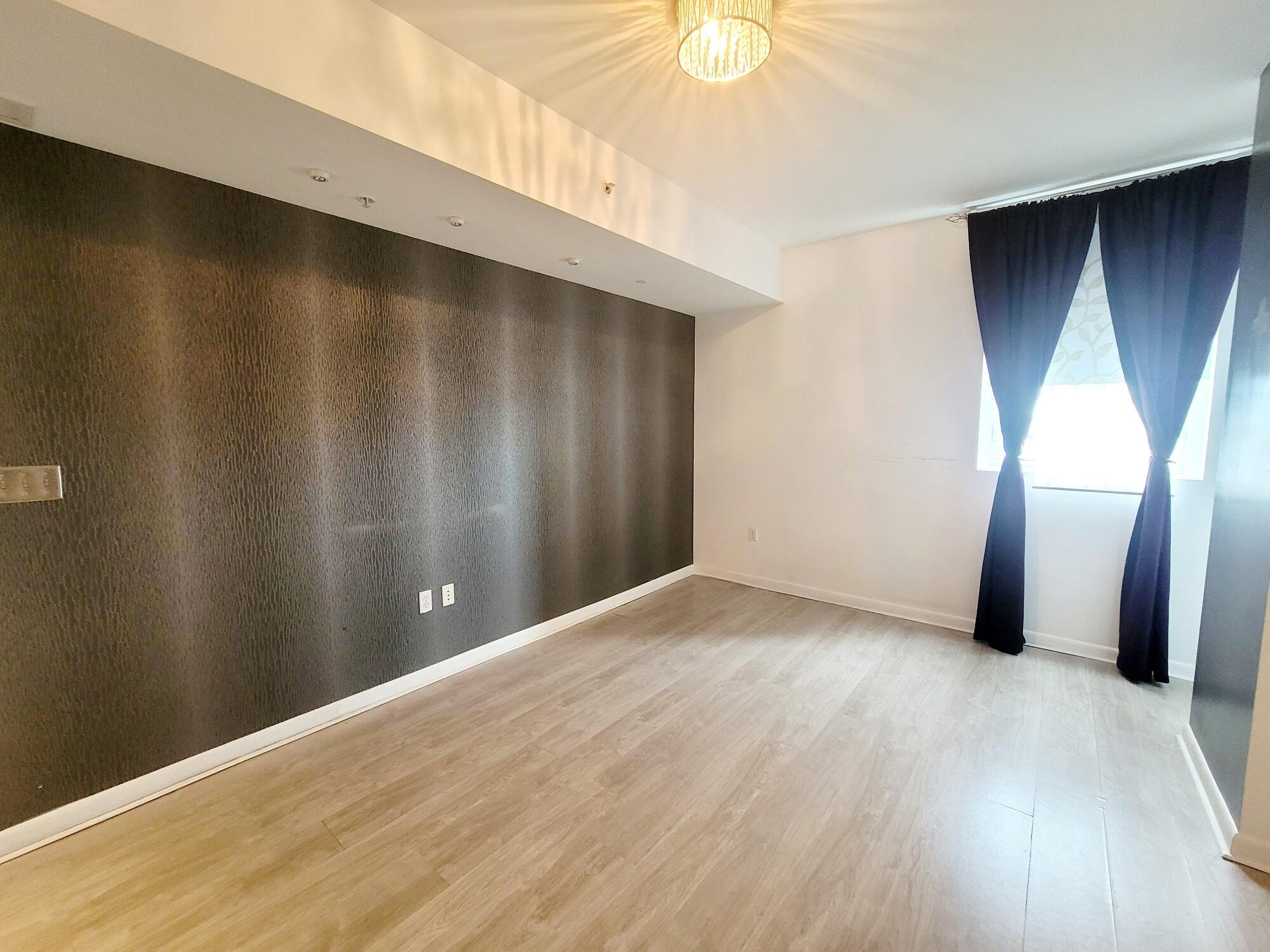244 Biscayne Boulevard, Unit 401 Miami, FL 33132 - Photo 27 of 36 a view of an empty room with wooden floor