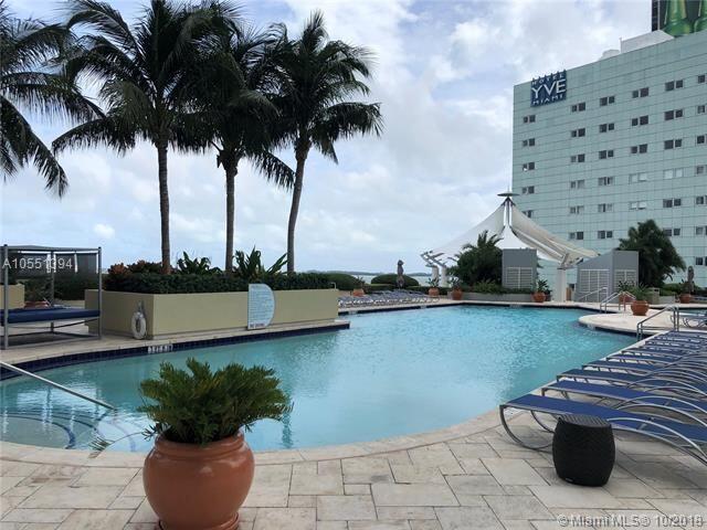 244 Biscayne Boulevard, Unit 401 Miami, FL 33132 - Photo 34 of 36 a view of a terrace with chairs and potted plants