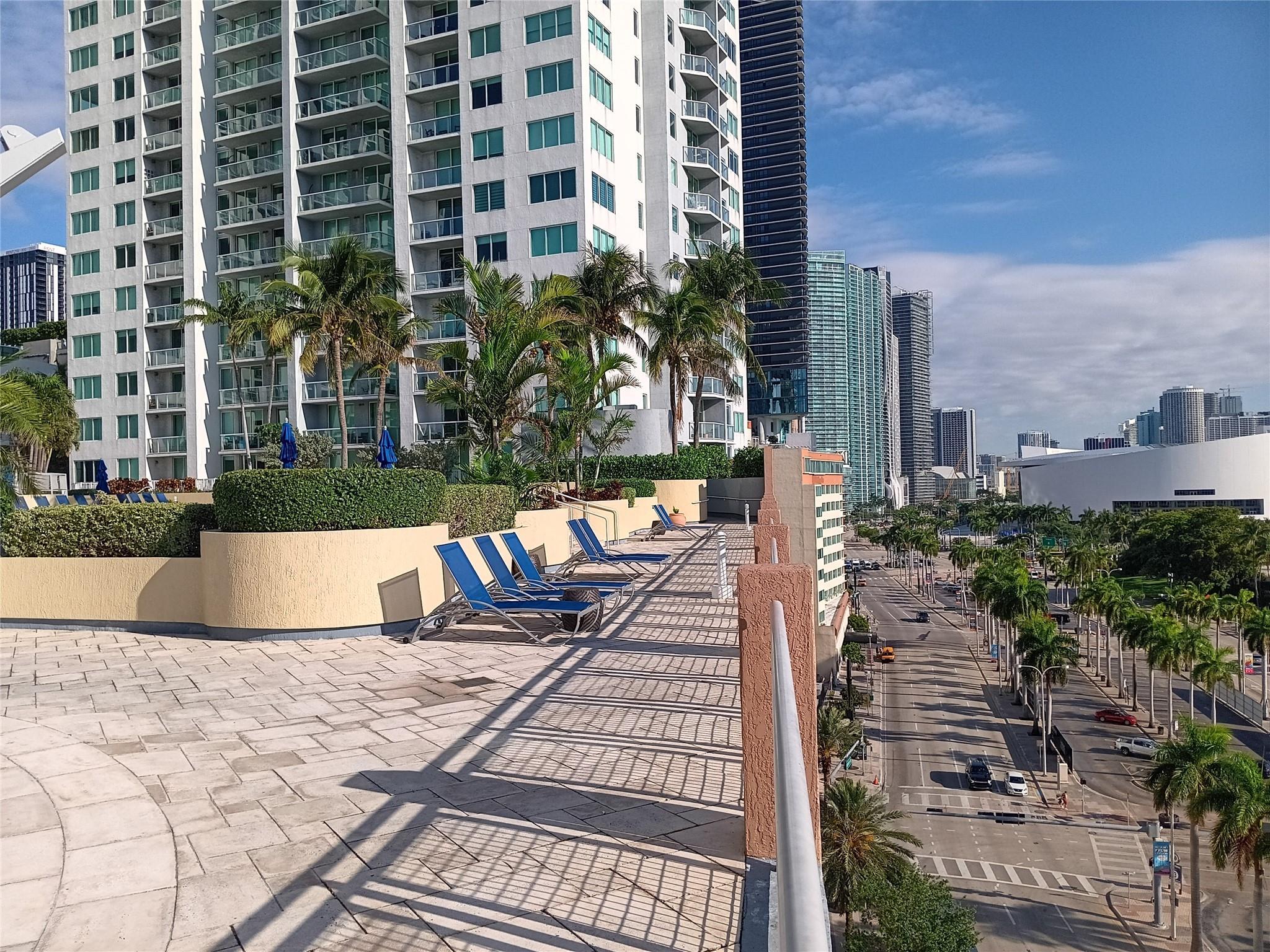 244 Biscayne Boulevard, Unit 401 Miami, FL 33132 - Photo 7 of 36 a view of a swimming pool with outdoor seating and plants
