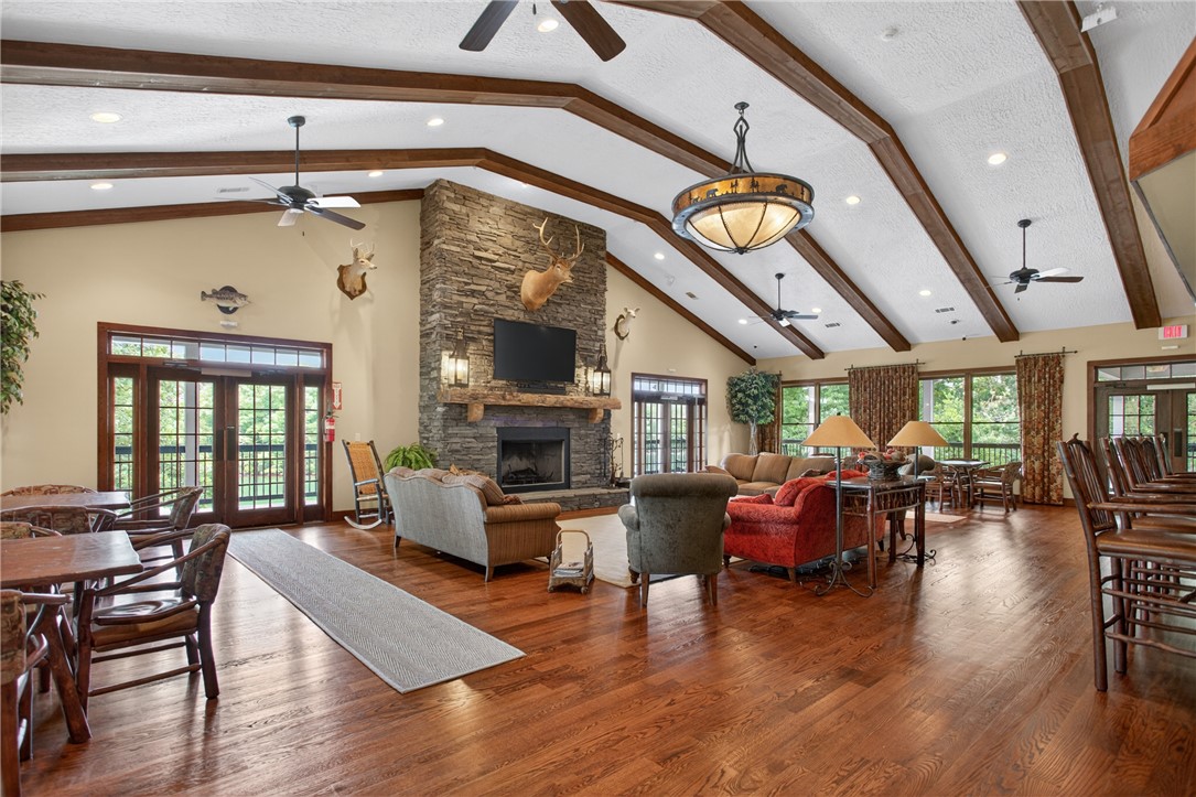 1230 Melton Road, Unit 4 West Union, SC 29696 - Photo 11 of 48 The lodge's inviting living area boasts high vaulted ceilings with exposed beams and a captivating stone fireplace.