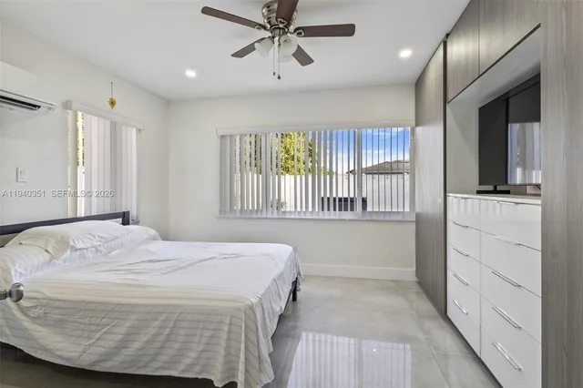 a bedroom with a large bed and a window