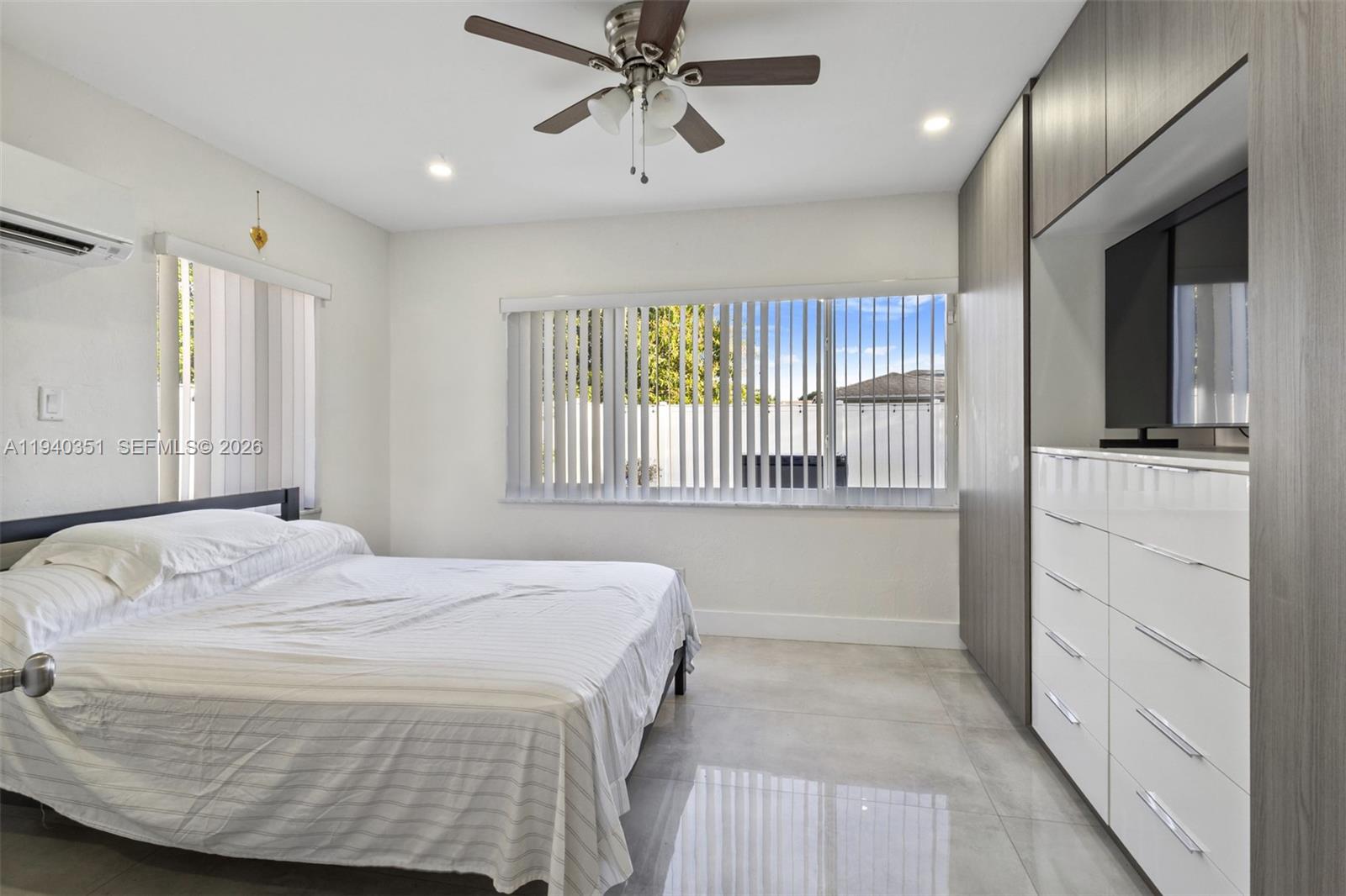 8014 Northwest 101st Avenue Tamarac, FL 33321 - Photo 11 of 16 a bedroom with a large bed and a window