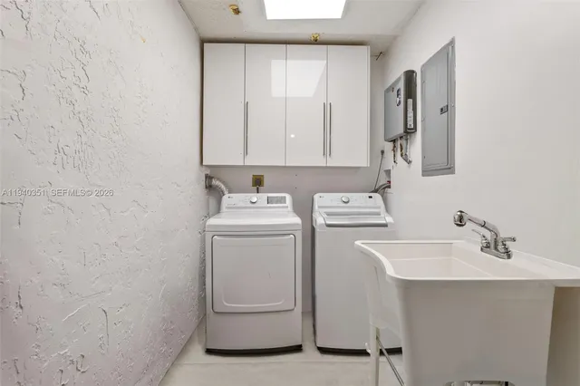 a bathroom with a sink a washer and dryer