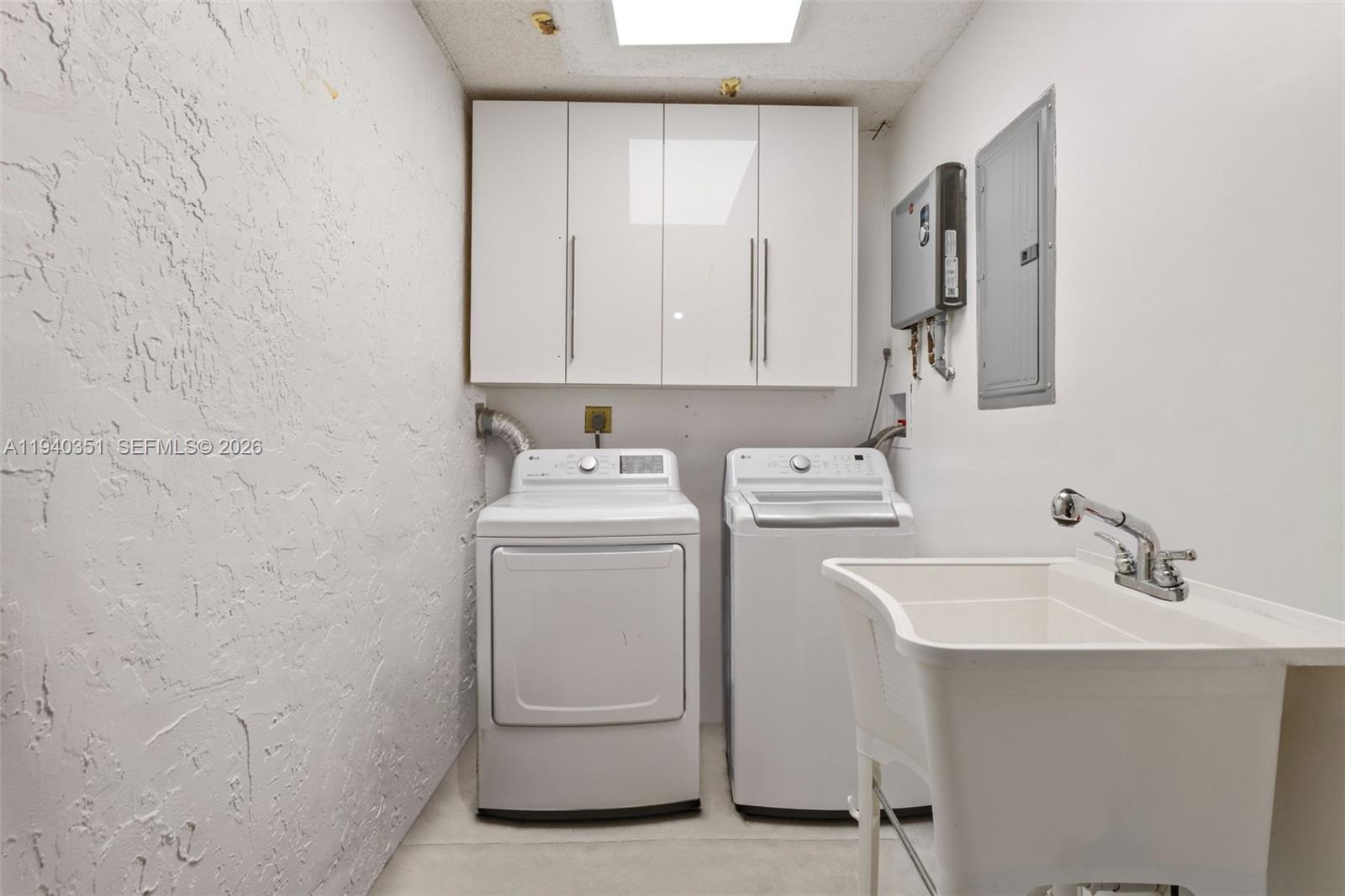 8014 Northwest 101st Avenue Tamarac, FL 33321 - Photo 15 of 16 a bathroom with a sink a washer and dryer