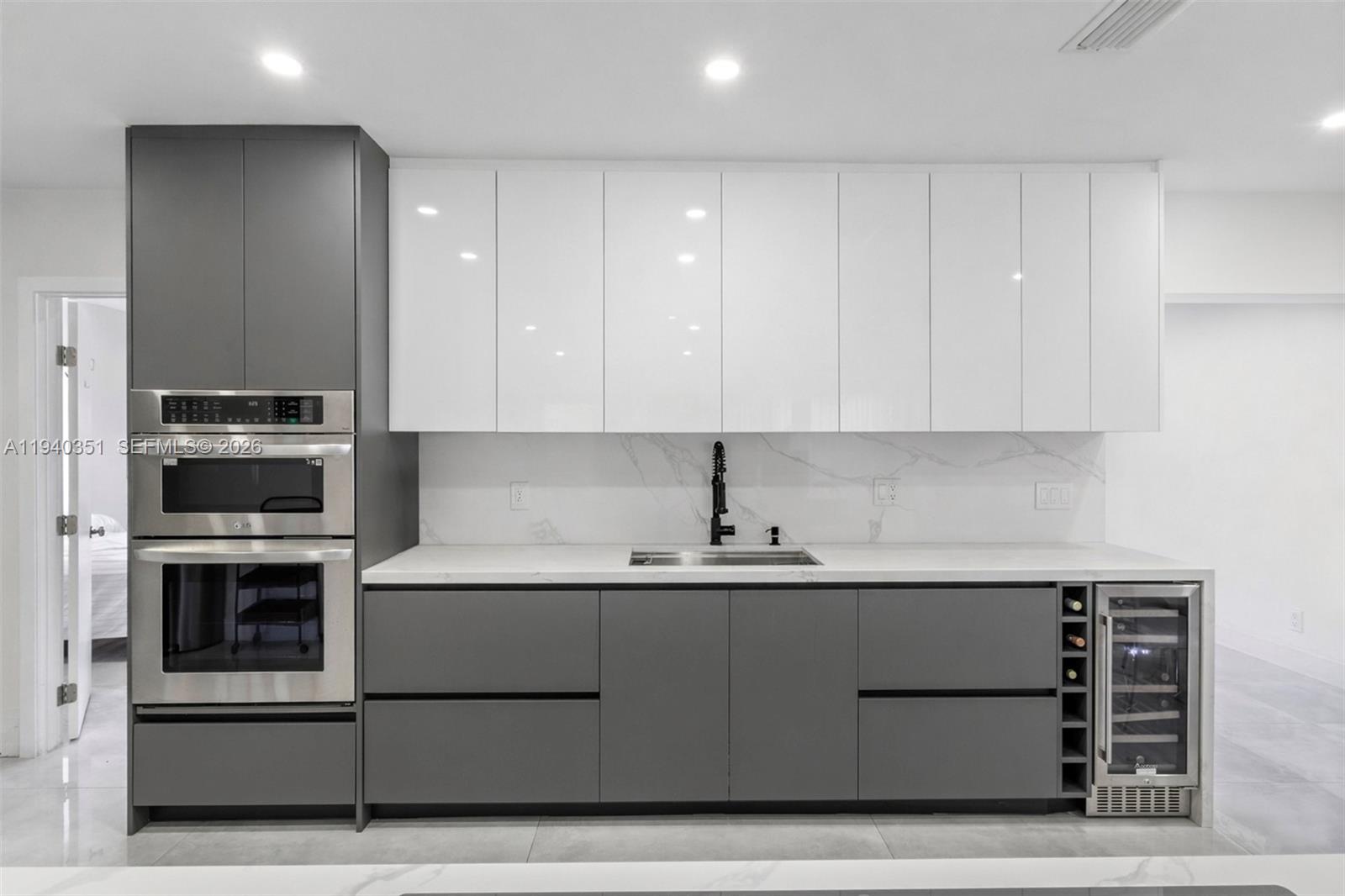 8014 Northwest 101st Avenue Tamarac, FL 33321 - Photo 5 of 16 a kitchen with stainless steel appliances granite countertop a sink stove and refrigerator