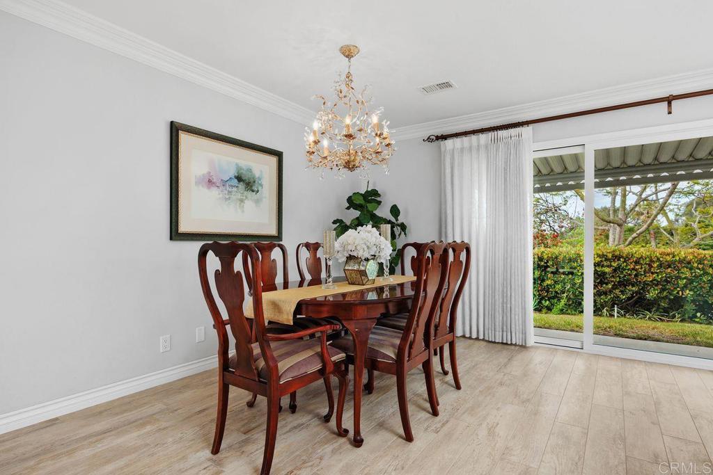 3709 Sesame Way Oceanside, CA 92057 - Photo 13 of 39 a dining room with furniture a large window and wooden floor