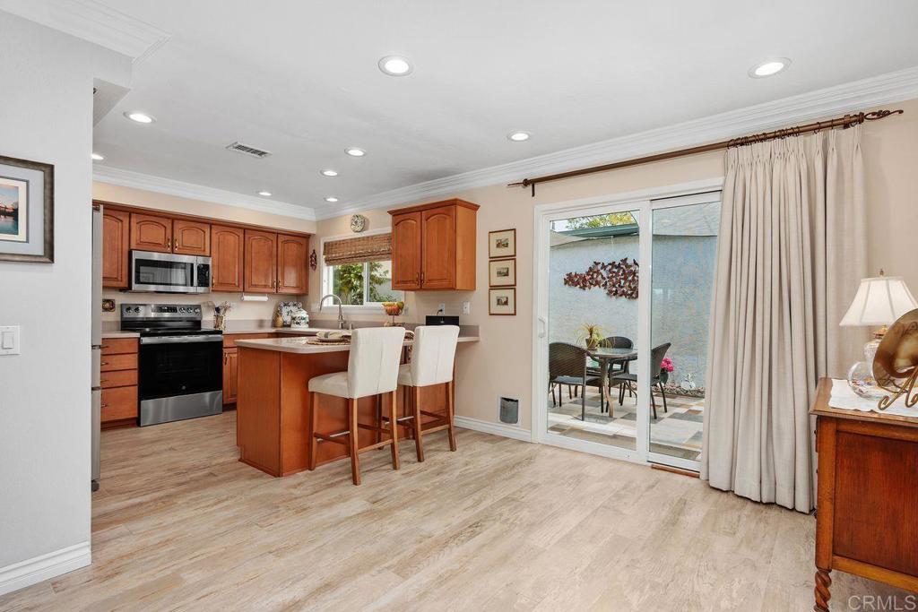 3709 Sesame Way Oceanside, CA 92057 - Photo 14 of 39 a living room with stainless steel appliances kitchen island granite countertop furniture a dining table and chairs