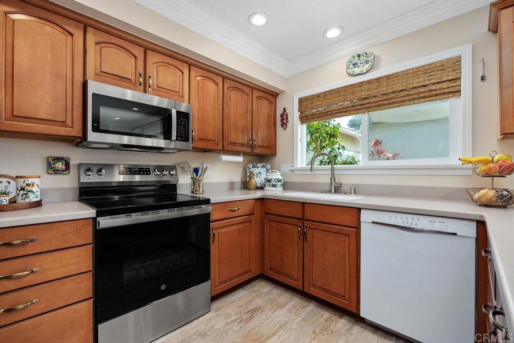 3709 Sesame Way Oceanside, CA 92057 - Photo 16 of 39 a kitchen with stainless steel appliances granite countertop wooden cabinets and a stove top oven