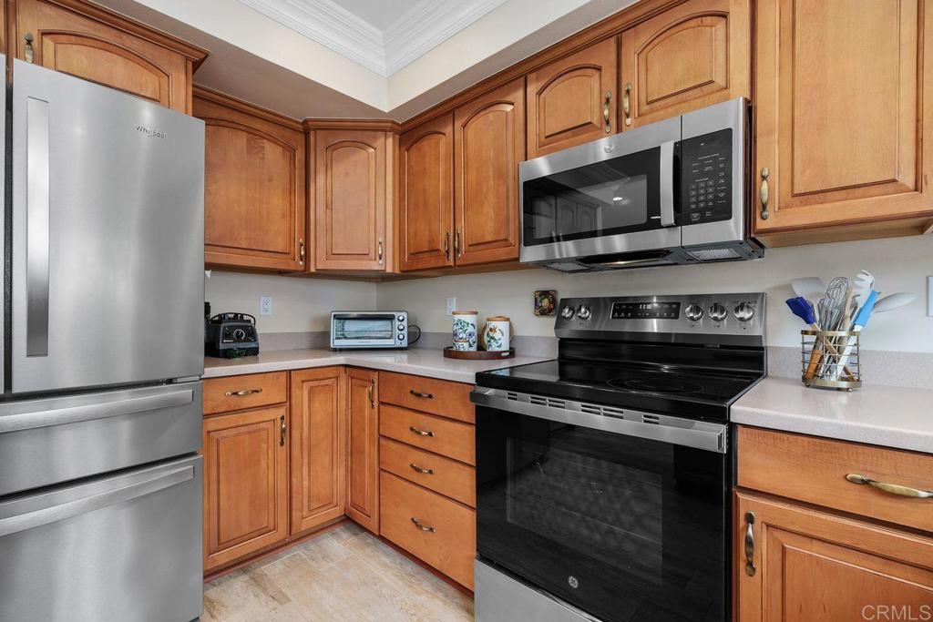 3709 Sesame Way Oceanside, CA 92057 - Photo 17 of 39 a kitchen with stainless steel appliances granite countertop a refrigerator stove top oven a sink and dishwasher