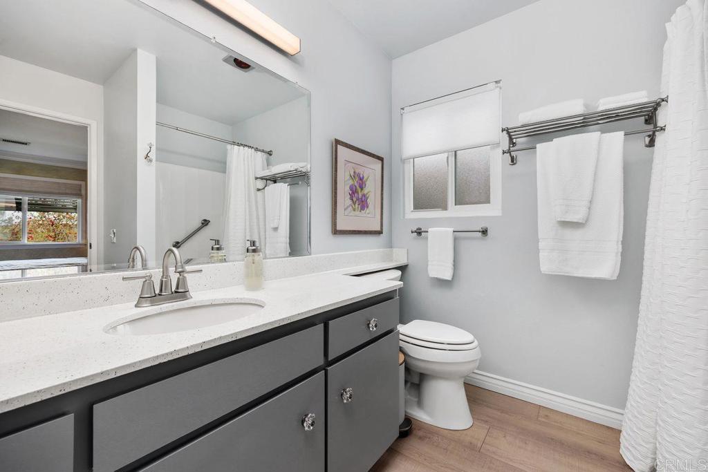 3709 Sesame Way Oceanside, CA 92057 - Photo 23 of 39 a bathroom with a sink a toilet a mirror and shower