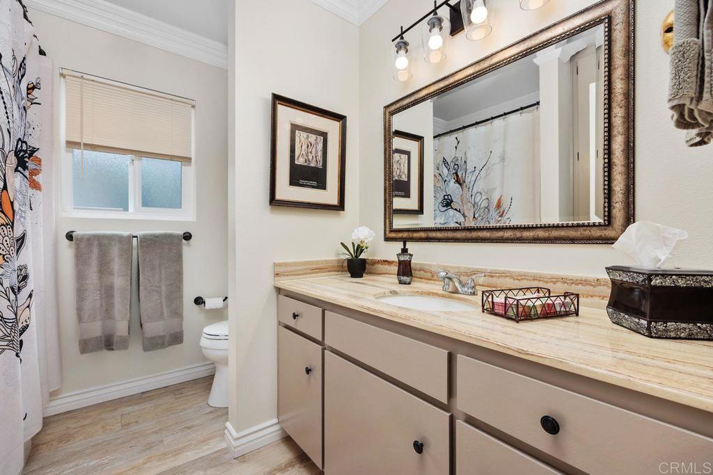 3709 Sesame Way Oceanside, CA 92057 - Photo 28 of 39 a view of a bathroom with a sink a mirror a toilet and a shower