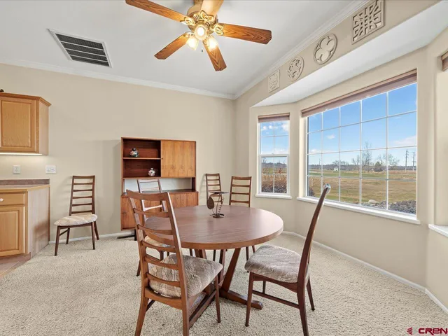 a view of a dining room with furniture window and outside view